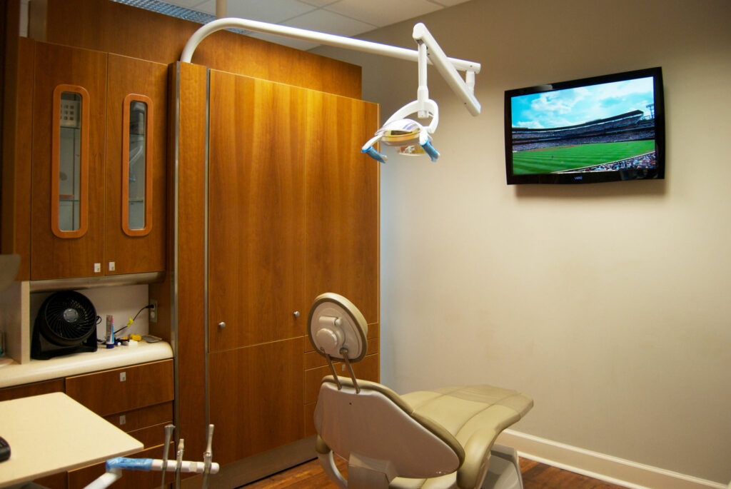 Photo of an operatory at Brooklane Family Dental with the operatory TV showing a baseball game